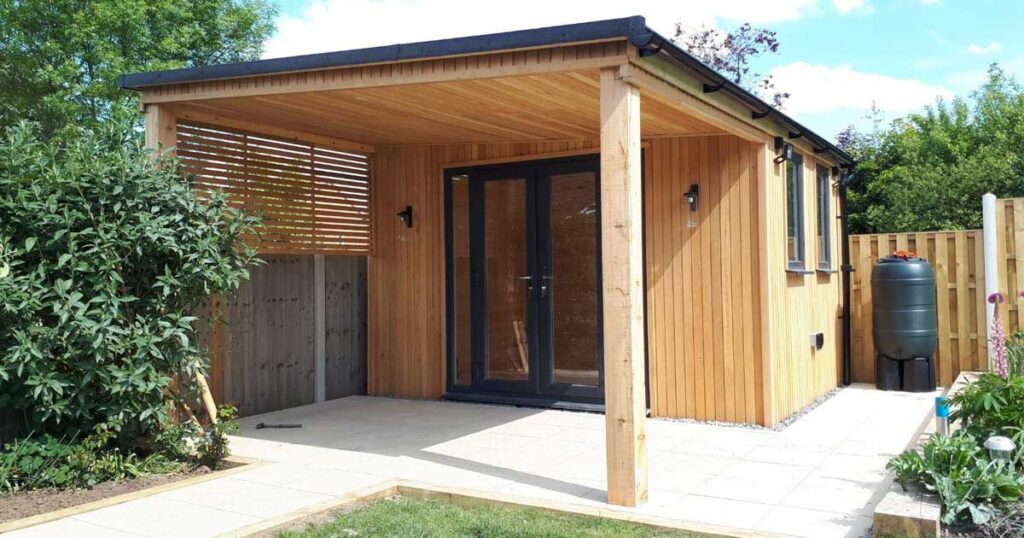 A luxury garden room with Siberian larch and overhanging roof.